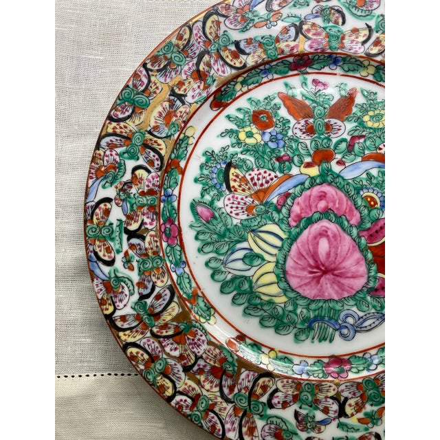 Thousand Butterflies pattern in a famille rose medallion style plate by Japanese Porcelain. Marked on the underside....
