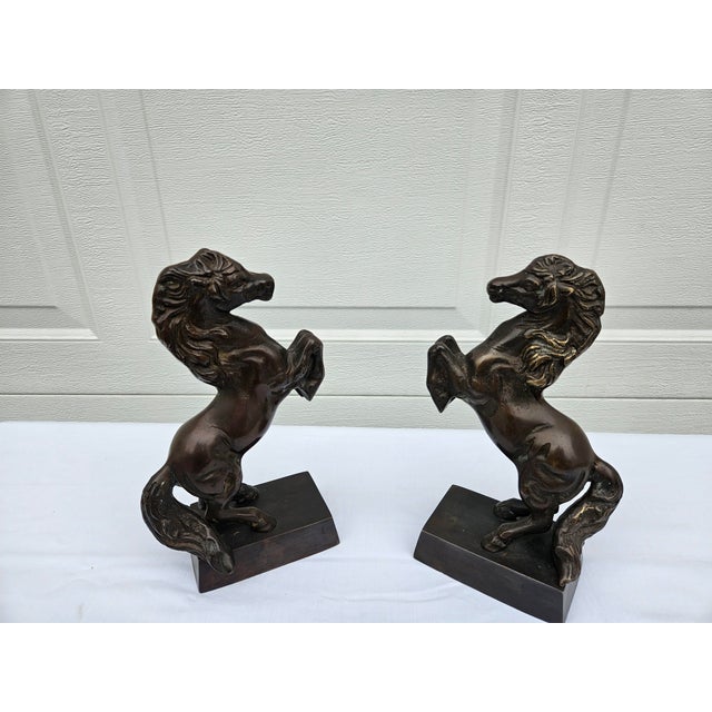 A pair of vintage bronze horse bookends or sculptures, just under 10” inches in height, and in good condition with a...