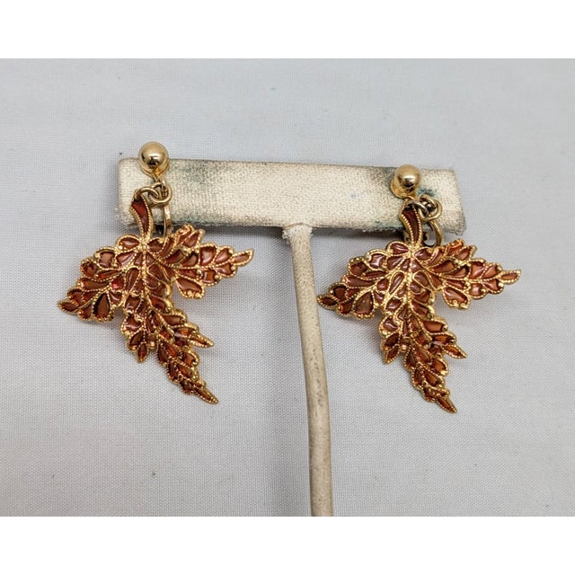 Rare 1960s goldtone orange plique-a-jour leaf dangle clip earrings. Marked "NAPIER©." Measure: 2 1/8 inches long by 1 7/16...