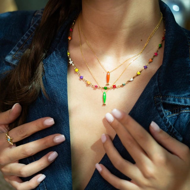 Add a pop of color and joy to your style with our Rainbow Stars & Hearts Choker Necklace. Featuring vibrant enamel stars...