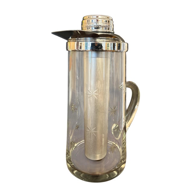 Fabulous rare pitcher. It's etched glass with etched star pattern and the handle is only attached on the bottom, very cool...