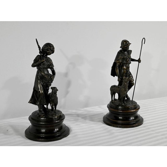 A pair of subjects in bronze with brown patina, signed Laurini on the terrace, after Louis and François Moreau....