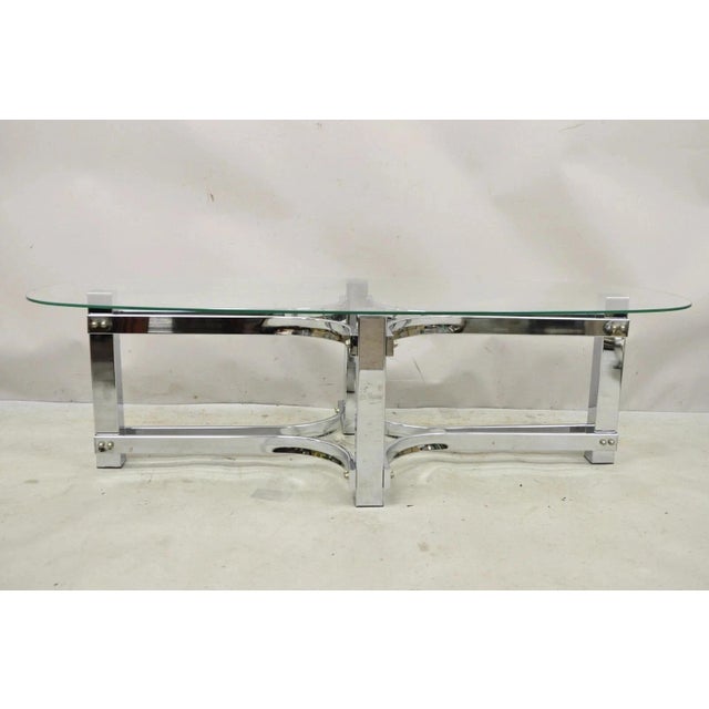Vintage Mid Century Modern Oval Glass Top Sculpted Chrome Frame Coffee Table. Circa Late 20th Century. Measurements: 14.5"...