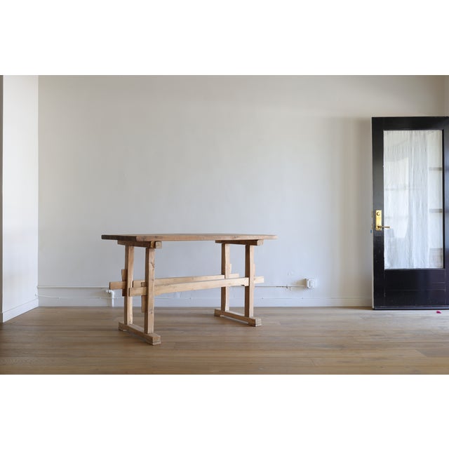 A classic French oak trestle work table, often referred to as a table de travail or table d’atelier, dating to the late...