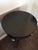 French Art Deco inspired round table with (3) arced legs made of mahogany veneers and solids with nickel ring pull and...