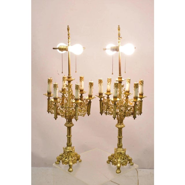 Antique Gothic Revival Gold Bronze Figural Candelabra Table Lamps - a Pair. Item features wooden decorative candles, twin...