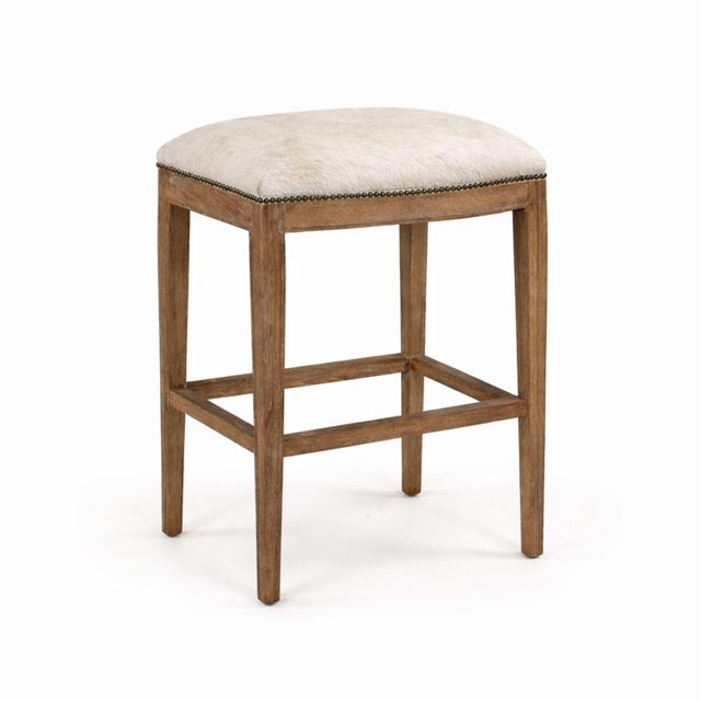 Elevate your space with this elegant bar stool, featuring a sturdy oak wood frame paired with a luxurious cowhide...