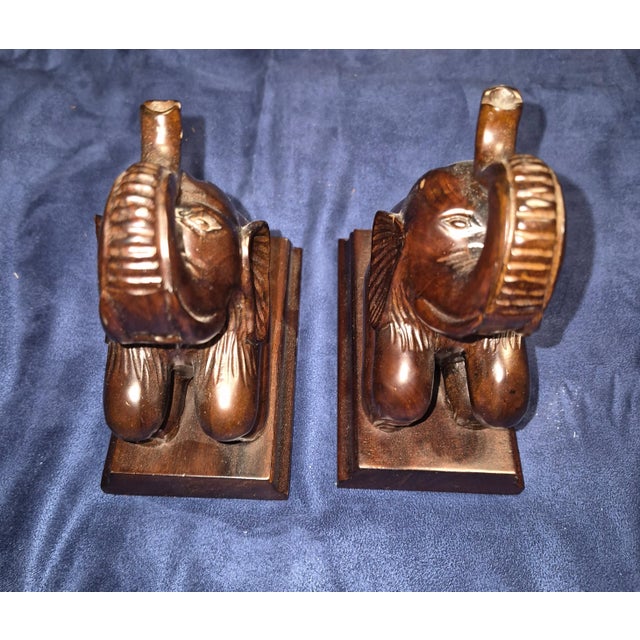 These vintage hand-carved hardwood elephant bookends feature a charming seated posture on rectangular wooden bases and are...