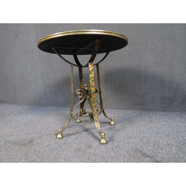 This unique metal table features Asian inspired top, as well as ornate rolled metal accenting. The gold finish gives this...