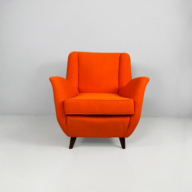 Italian mid-century modern orange fabric and wood armchair, 1950s Armchair with padded seat, back, and armrests...