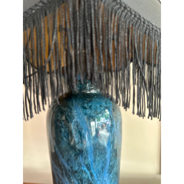 Deep teal/cobalt body with striking natural veining—highly polished and set on a hardwood plinth. Brass fittings; works...