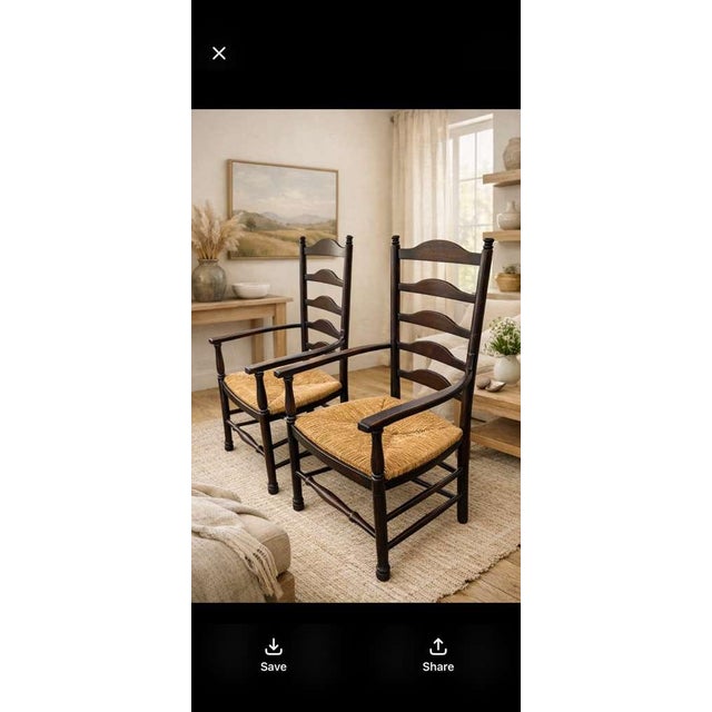 A classic pair of vintage ladder back armchairs, crafted and solid dark stained wood, with hand, woven rush, seats....