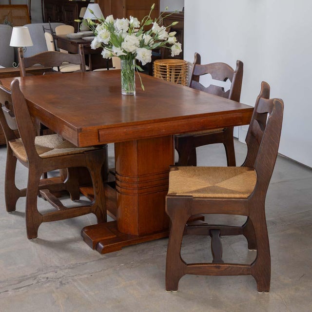 Stunning set of 6 dining chairs, made of solid oak with original woven rush seat in the style of Guillerme & Chambron....