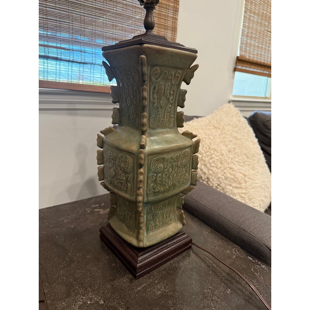Elegant vintage Asian-inspired ceramic table lamp featuring a celadon crackle glaze with raised relief detailing. The...