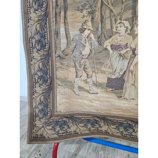 The tapestry depicts an idyllic, forest genre scene in shades of beige and brown. In the foreground there are groups of...