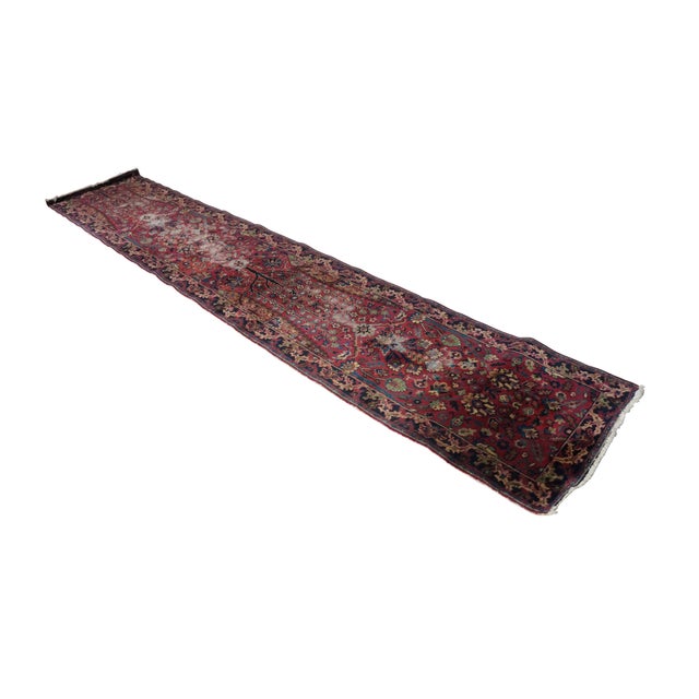 This antique hand-knotted `tree-of-life runner rug showcases a remarkably intricate, dense design despite experiencing...
