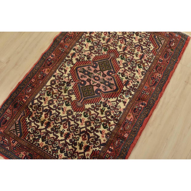 An authentic vintage tribal Hamedan rug hand-knotted with fine wool and natural dyes. This nomadic rug features a central...