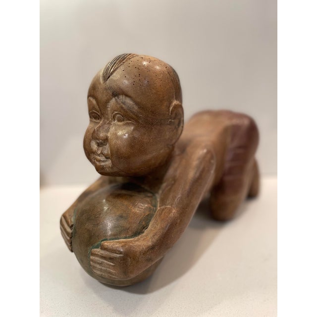 This hand-carved wooden sculpture is often referred to as a "Baby Buddha" or a "Lucky Thai Baby Buddha," and sometimes as...
