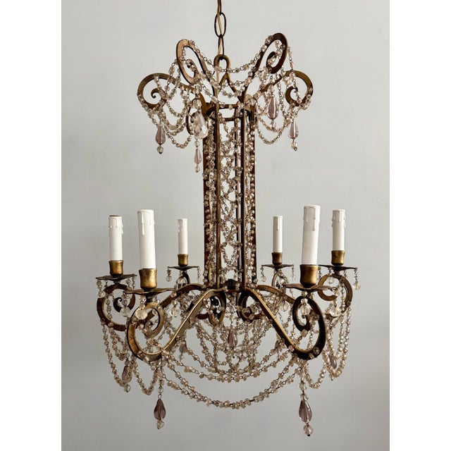 Rare and beautiful, 1920s/30s Italian gilt iron and blown-glass beaded chandelier. The chandelier consists of a rolled and...