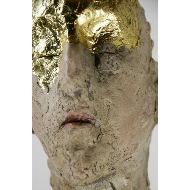 This figurative mixed media bust sculpture in ceramic, metallic oxides and carved fir wood opens with a strong emphasis on...