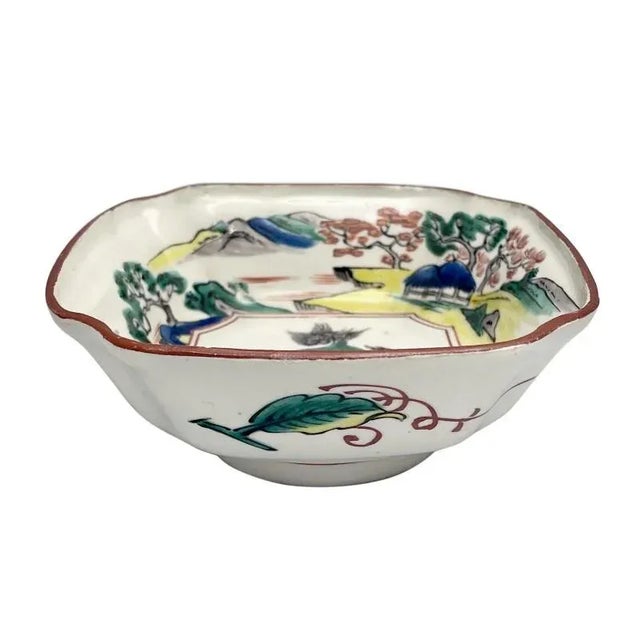 A small well painted Japanese porcelain dish from the Edo period. Enameled in the old Kutani pallete of deep green,...