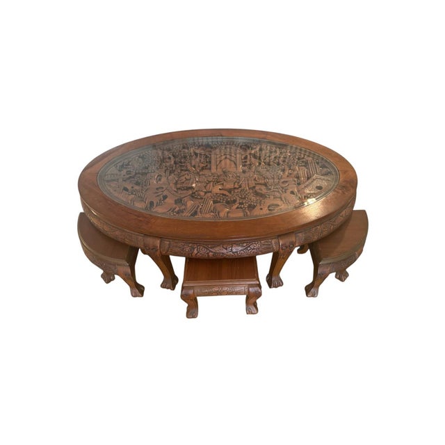 This Vintage Oriental Hand-Carved Teak Coffee Tea Table with 6 Nesting Stools is a stunning piece that blends timeless...