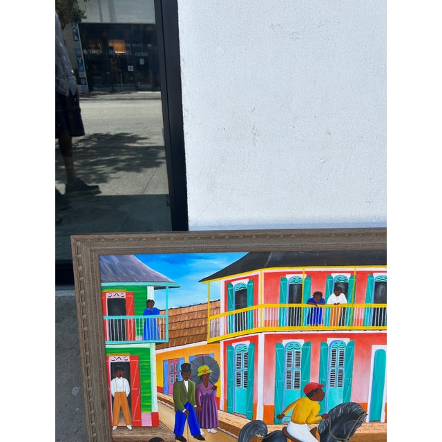 Striking vintage Haitian acrylic painting on board of a busy street scene executed and a distinctive naïve style, signed...
