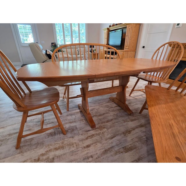 Vintage Hunt Country Furniture "Hancock" trestle base extension dining table crafted in Oak in the Light Honey finish. Set...