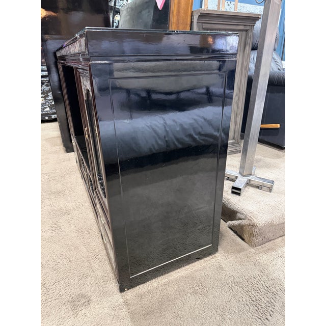 Striking and richly detailed, this black lacquer sideboard is a masterful expression of traditional Asian craftsmanship....