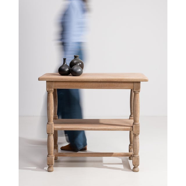 A refined oak console table featuring beautifully turned legs that add depth and character to the design. The solid...
