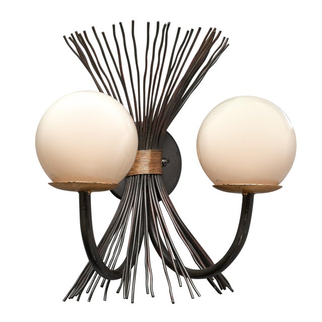 Pair of sconces from Italy made of iron with two arms capped with hand-blown Murano glass globes. Gold leafed accents....