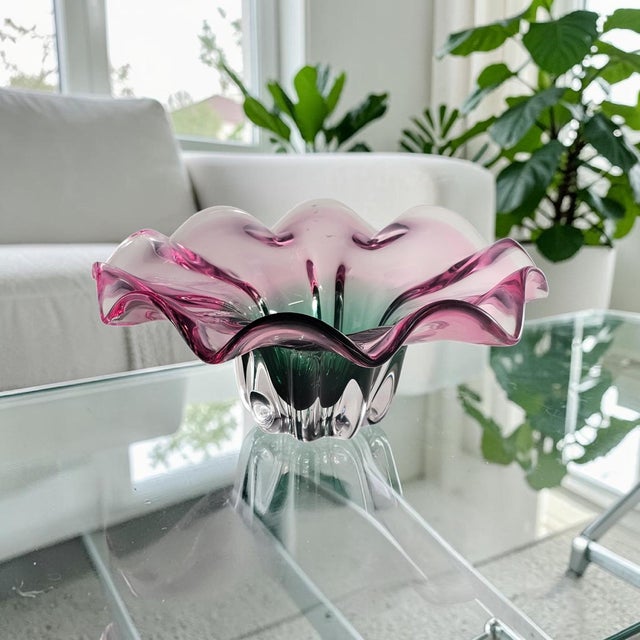 A large-scale sommerso art glass centerpiece bowl executed in the Murano style, combining a saturated emerald green core...