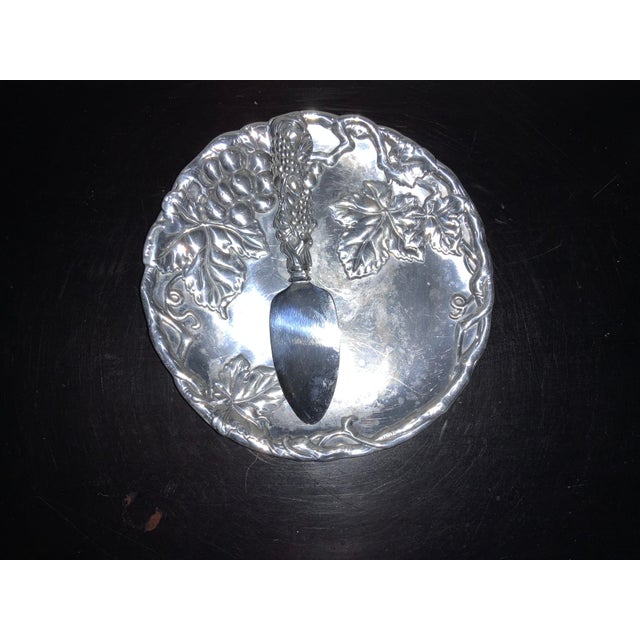 Arthur Court two piece cheese serving set including 8 inch plate and 7 inch cheese knife. Decorated in a grape and leaf...