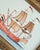 A charming sailboat painting, hand-painted by master artists using acrylic paints and natural pigments. The artwork...