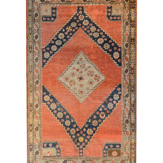 A mesmerizing early 20th century Central Asian Samarkand rug with a large central diamond medallion with a stylized floral...