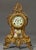 This is a very elegant clock with a porcelain face and a porcelain plaque in the opening below the face with a painted...