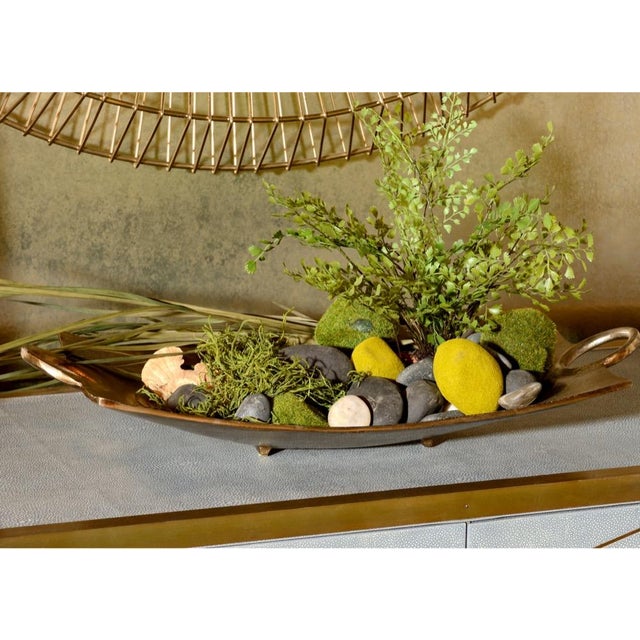 Enhance your home or office decor with this captivating handled dish. Crafted in cast aluminum with a radiant bronzed...