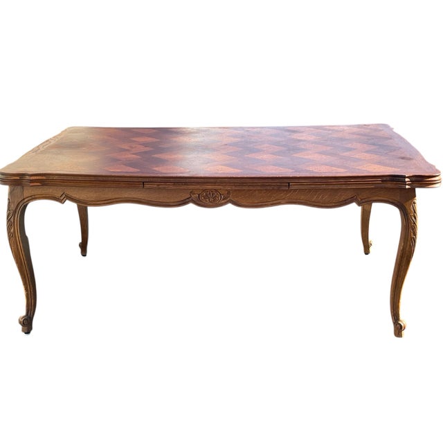 A fabulous 19th century example from France. Parquetry top with 2 sliding leaves stored underneath. Beautiful parquet top...