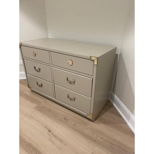 Offered is a vintage campaign style dresser by Thomasville. This piece features original brass hardware and accents and...