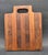 Offered is a handcrafted Teak wood end-grain cutting board featuring an integrated handle cutout and alternating hardwood...