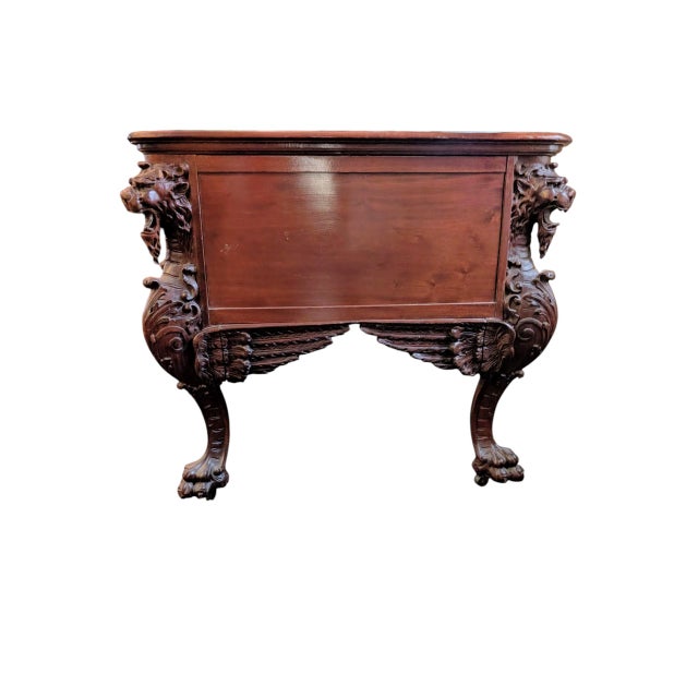 Gorgeous, heavily carved mahogany partner's desk featuring winged griffins, gargoyles, bird and floral motifs throughout...