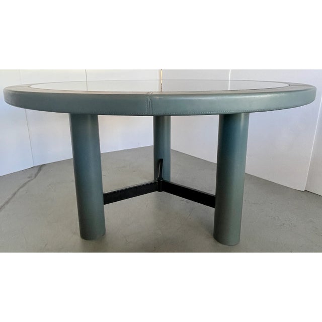 Italian Postmodern dining or entry hall table. Three cylindrical legs covered with gray leather. Top is covered with gray...