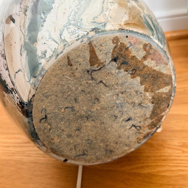 A striking pair of vintage table lamps finished in a richly marbled glaze that evokes natural stone, agate, or flowing...