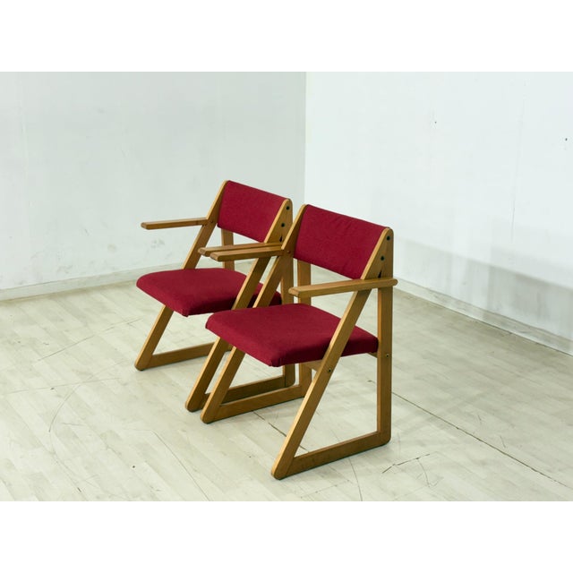 For sale is a stylish vintage armchair from the 1960s. The chair impresses with its clean lines, sturdy wooden frame...