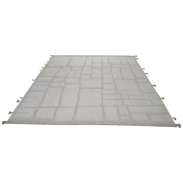 Hand-knotted with care using traditional rug making techniques, this wool rug blends timeless craftsmanship with a modern...