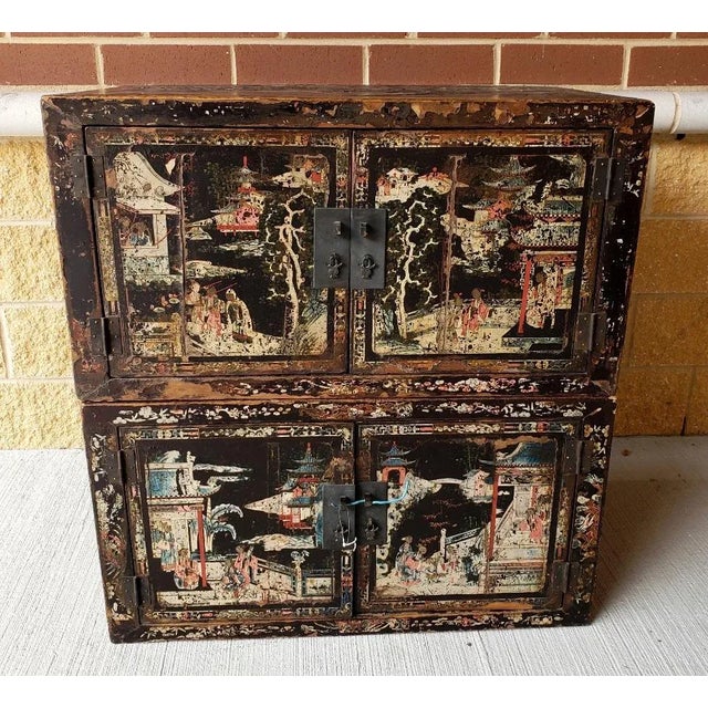 A beautiful and very functional pair of antique Chinese wooden cabinets with detailed court scenes. The cabinets can be...