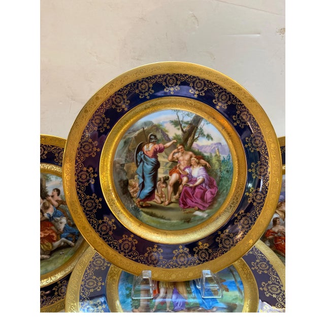 An elaborate set of 12 Royal Vienna porcelain hand painted cabinet plates with cobalt and gold borders. The plates measure...
