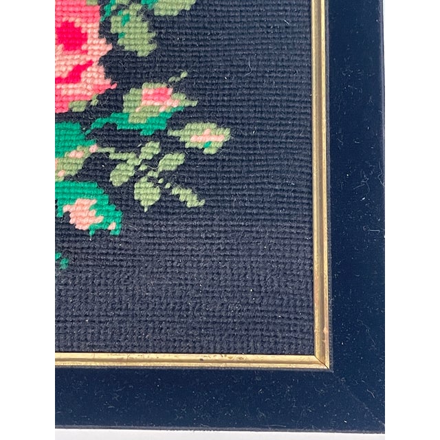 Antique needlepoint pink roses on black velvet frame.