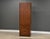 A mid century modern walnut tall dresser armoire with one large door, adjustable shelving and lower drawers made by...