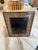 A rectangular picture frame with a warm woven rattan surround and a slim metal border. The natural texture gives it a...